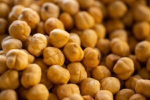 A close-up of many roasted chickpeas showcasing their texture and golden color.