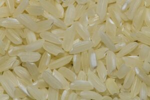 Detailed macro shot of uncooked rice grains, perfect for food and grain photography.