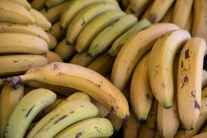 A detailed close-up shot of fresh ripe organic bananas showcasing their vibrant yellow color and texture.